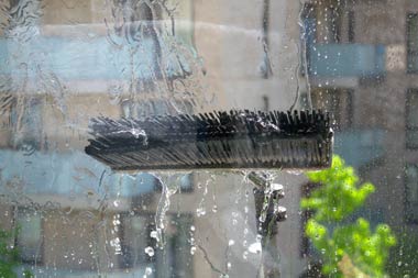 A brush cleaning a window