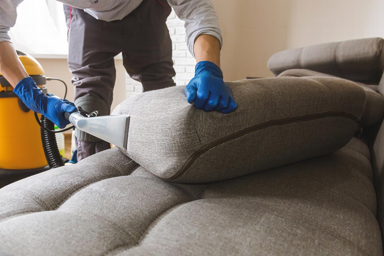 Man cleaning sofa upholstery in Colchester